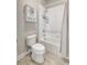 Bright bathroom with shower/tub combo, white fixtures, and cabinet for extra storage at 13918 Old Creek Ct, Parrish, FL 34219