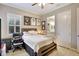 Comfortable bedroom features wood-look flooring, ceiling fan, and serene natural light at 13918 Old Creek Ct, Parrish, FL 34219