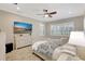 Beautiful bedroom with a large TV, a ceiling fan, and lots of natural light at 13918 Old Creek Ct, Parrish, FL 34219