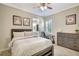 Comfortable bedroom with wood-look tile flooring, desk area and bathroom access at 13918 Old Creek Ct, Parrish, FL 34219