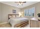 Cozy bedroom with a wooden bed frame, a ceiling fan, and shuttered windows at 13918 Old Creek Ct, Parrish, FL 34219
