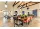 Spacious dining area with wood beams, large tables, and stylish seating at 13918 Old Creek Ct, Parrish, FL 34219