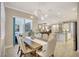 Elegant dining room has a table for six and is adjacent to the kitchen and living room at 13918 Old Creek Ct, Parrish, FL 34219