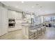 Bright kitchen features a center island, modern appliances, tile flooring and eat in bar seating at 13918 Old Creek Ct, Parrish, FL 34219