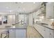 Gourmet eat-in kitchen has an island with sink, stainless dishwasher, and tile flooring at 13918 Old Creek Ct, Parrish, FL 34219