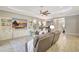 Spacious living room featuring a large TV, built-in shelving, and comfortable seating arrangements at 13918 Old Creek Ct, Parrish, FL 34219