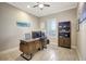 Bright home office has a ceiling fan, built-in shelving, and plantation shutters at 13918 Old Creek Ct, Parrish, FL 34219