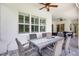 Covered patio with an outdoor dining area, ceiling fans, and brick flooring at 13918 Old Creek Ct, Parrish, FL 34219