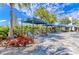 Resort-style pool area with cabanas, lounge chairs, and lush landscaping at 13918 Old Creek Ct, Parrish, FL 34219