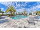 Resort-style community pool with palm trees, lounge chairs, and beautiful blue skies at 13918 Old Creek Ct, Parrish, FL 34219