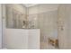 Glass enclosed shower featuring neutral tile, a built-in bench, and modern fixtures at 13918 Old Creek Ct, Parrish, FL 34219