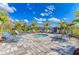 Relaxing community spa area surrounded by lounge chairs, palm trees, and lush landscaping at 13918 Old Creek Ct, Parrish, FL 34219