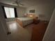 Bright bedroom featuring tile flooring, natural lighting, and a coordinated bedroom set at 1500 Crest Dr, Englewood, FL 34223