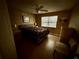A primary bedroom features a ceiling fan, a window, and neutral-toned walls at 1500 Crest Dr, Englewood, FL 34223
