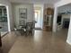 Inviting dining area with tile flooring, table with seating and a decorative grandfather clock at 1500 Crest Dr, Englewood, FL 34223