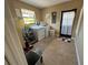 Functional laundry room with washer, dryer, window, tile flooring and neutral paint at 1500 Crest Dr, Englewood, FL 34223