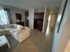 Bright living room features tile floors, a white sofa, and a built-in desk at 1500 Crest Dr, Englewood, FL 34223