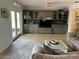 Comfortable living area featuring built-in shelves, a ceiling fan and sliding glass doors at 1500 Crest Dr, Englewood, FL 34223