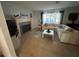 Comfortable living room with fireplace, tile floors and abundant natural light from large windows at 1500 Crest Dr, Englewood, FL 34223