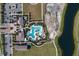 Overhead view of a resort-style pool, elegant clubhouse, ample parking, and scenic surroundings in a residential area at 16807 Barnwood Pl, Bradenton, FL 34211