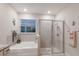 Bright bathroom featuring a tub and glass-enclosed shower at 16807 Barnwood Pl, Bradenton, FL 34211