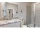 Bright bathroom featuring a granite countertop vanity and glass-enclosed shower at 16807 Barnwood Pl, Bradenton, FL 34211