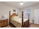 Cozy bedroom with a decorative four-poster bed and hardwood floors at 16807 Barnwood Pl, Bradenton, FL 34211