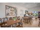 A stylish dining area with modern tables and chairs, complemented by decorative artwork and abundant natural light at 16807 Barnwood Pl, Bradenton, FL 34211