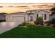 Attractive home with a three car garage, stone accents, mature landscaping, and a meticulously maintained lawn at 16807 Barnwood Pl, Bradenton, FL 34211
