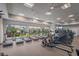 Bright fitness center with treadmills, rowing machines, and large windows overlooking greenery at 16807 Barnwood Pl, Bradenton, FL 34211