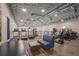 Modern gym with treadmills, ellipticals, and a comfortable seating area for a complete fitness experience at 16807 Barnwood Pl, Bradenton, FL 34211
