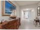 Inviting hallway with stylish decor, leading to a bright entryway with decorative glass and neutral tones at 16807 Barnwood Pl, Bradenton, FL 34211