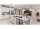 Open-concept kitchen featuring white cabinets, granite countertops, and stainless steel appliances at 16807 Barnwood Pl, Bradenton, FL 34211