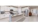 Bright kitchen features white cabinetry, stainless steel appliances, and a granite countertop island at 16807 Barnwood Pl, Bradenton, FL 34211