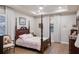 Comfortable main bedroom featuring wood floors, a tray ceiling, and serene natural lighting at 16807 Barnwood Pl, Bradenton, FL 34211
