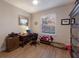 Home office with a traditional desk, wood floors, and a bright window at 16807 Barnwood Pl, Bradenton, FL 34211