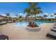 Resort-style pool area with ample seating, lush palm trees, and inviting cabanas for ultimate relaxation at 16807 Barnwood Pl, Bradenton, FL 34211