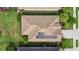 Aerial view of a unique tile roof with solar panels, and lush backyard at 17018 Blue Ridge Pl, Bradenton, FL 34211