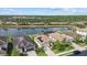 An aerial view of luxury homes in a beautiful community with a lake view and solar panels at 17018 Blue Ridge Pl, Bradenton, FL 34211
