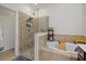 Stylish bathroom featuring tiled shower, soaking tub, and modern fixtures at 17018 Blue Ridge Pl, Bradenton, FL 34211
