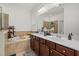 Luxurious bathroom with double sink vanity, soaking tub, and tiled shower at 17018 Blue Ridge Pl, Bradenton, FL 34211