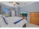 Bright bedroom with large window, TV, and view to other rooms at 17018 Blue Ridge Pl, Bradenton, FL 34211