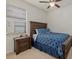 This bedroom boasts a wood bed frame, ceiling fan and a sunlit window for a warm comfortable vibe at 17018 Blue Ridge Pl, Bradenton, FL 34211