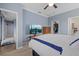 Comfortable bedroom with a TV, walk-in closet, and neutral color scheme at 17018 Blue Ridge Pl, Bradenton, FL 34211