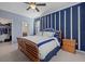 Stylish bedroom features a wooden bed frame and a modern accent wall at 17018 Blue Ridge Pl, Bradenton, FL 34211