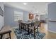 Cozy dining area featuring neutral colors, a modern table set, and views into the kitchen at 17018 Blue Ridge Pl, Bradenton, FL 34211