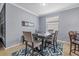 Dining area featuring a table set for four with views of the kitchen and living area at 17018 Blue Ridge Pl, Bradenton, FL 34211