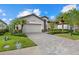 Charming single-story home with a paved driveway and lush landscaping at 17018 Blue Ridge Pl, Bradenton, FL 34211