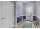 Inviting foyer featuring a decorative front door, wainscoting, ceramic tile, and neutral paint at 17018 Blue Ridge Pl, Bradenton, FL 34211