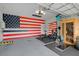 Garage transformed into workout space, featuring sauna, weight equipment and large American flag at 17018 Blue Ridge Pl, Bradenton, FL 34211